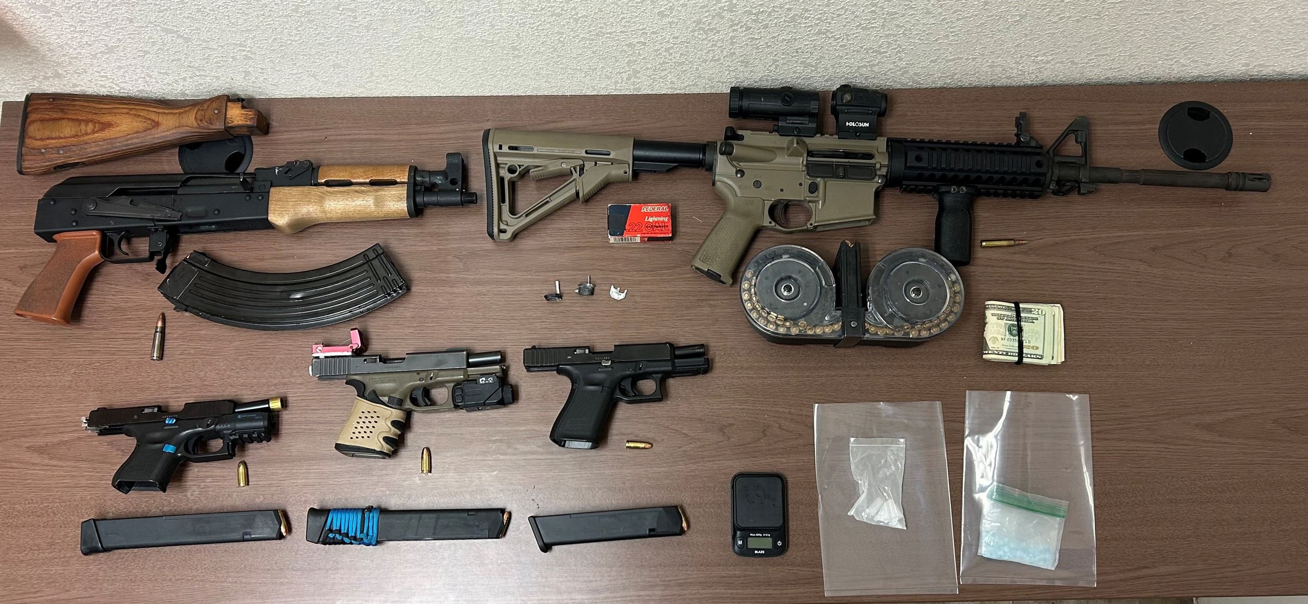 photo of guns and drugs seized from home where juvenile escapees arrested